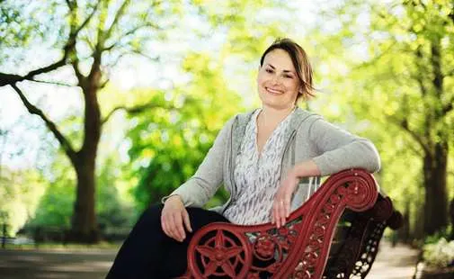 Yulia sitting on a bench in the park